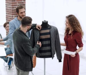 Fashion team evaluating a jacket design, symbolizing critique and rejection in the modeling industry