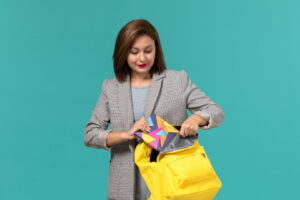 Model preparing for casting, placing essentials into a backpack, showcasing what’s in a model’s bag for castings and callbacks